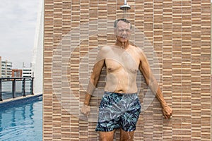 Man rinsing off in an outdoor shower