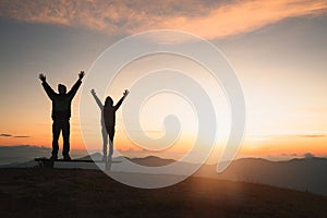 Man rise hand up on top of mountain and sunset,  Freedom and travel adventure concept. Religious beliefs, Copy space photo