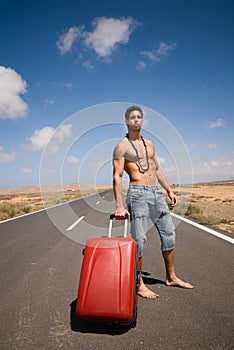 Man on the road with his suitcase