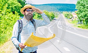 Man at road side with map. Expeditor backpacker map look orienteering direction. Orienteering topographic map. Expeditor