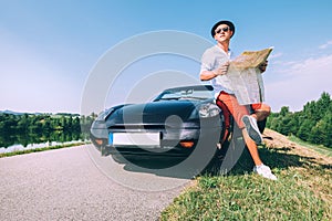 Man with roads map rest on road an planning his travel