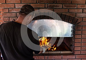 Man roasts barbecue near the stove