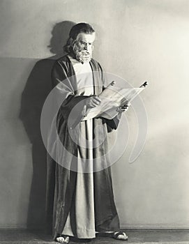 Man in robe reading scroll