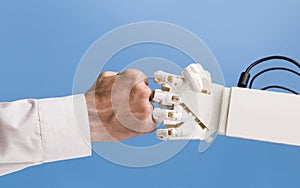 Man and robot hands making fist bump gesture