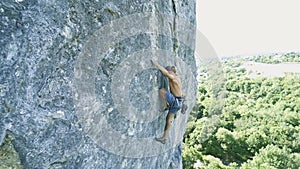Man rock climber climbing on a limestone cliff