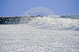 Man on Rock Jetty During Storm