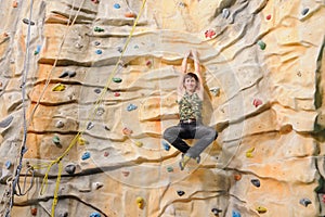 Man on rock wall in sport center