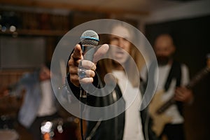 Man rocker wearing style with black jacket and white t-shirt with microphone