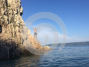 Man at the rocks in Adriatic sea