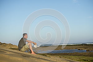 Man on Rocks with Book and Music