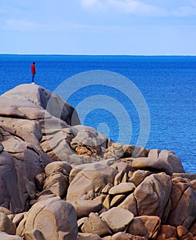 Man on rocky Cliff looking over the edge