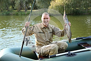 Man with rod and catch fishing from boat