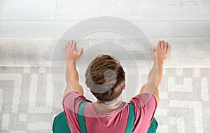 Man rolling out new carpet flooring indoors