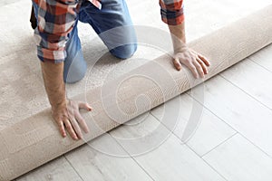 Man rolling out new carpet flooring