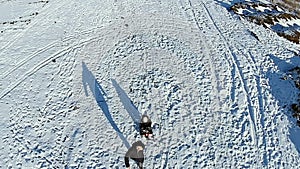 Man rolls kid fast on a sled