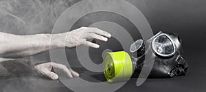 Man in room filled with smoke, trying to reach for vintage gasmask - Green filter