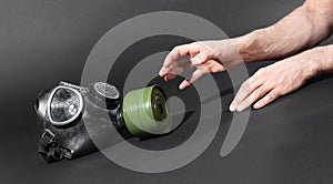 Man in room, trying to reach for vintage gasmask - Green filter