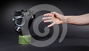 Man in room, trying to reach for vintage gasmask - Green filter