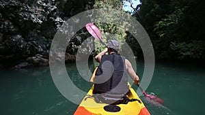 man rowing kayak across sea water