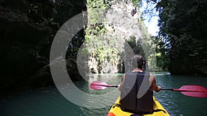 man rowing kayak swim down the river