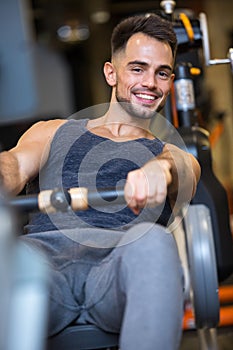 Man on rowing machine smiling to camera