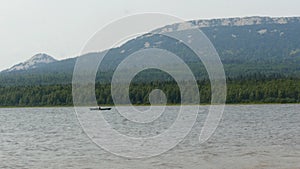 Man rowing oars in a boat in the lake
