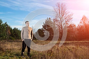 A man in rubber boots is standing in nature. The concept of outdoor recreation