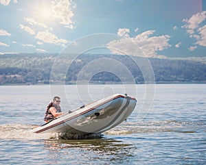 Man in rubber motor boat