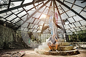 Man in ruined greenhouse