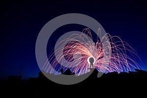 Man on a ruined staircase making rings of fire