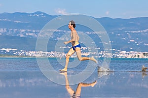 Man run across the beach