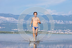 Man run across the beach