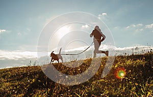 Man runing with his beagle dog at sunny morning. Healthy lifestyle and Canicross exercises jogging concept image