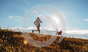 Man runing with his beagle dog at sunny morning. Healthy lifestyle and Canicross exercises jogging concept image photo