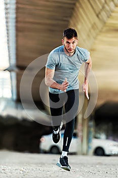 Man runner having intensive training outdoors.