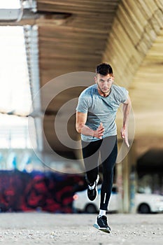 Man runner having intensive training outdoors.