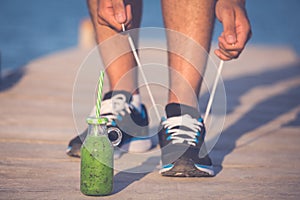 Man runner tying laces before training