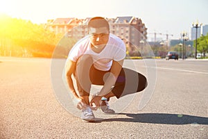 Man runner tying shoelaces