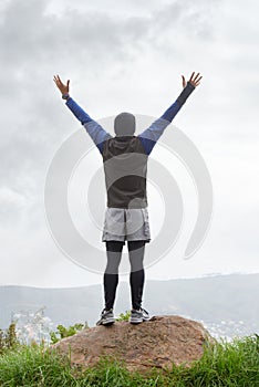 Man, runner or victory on mountain peak for training adventure, exercise or workout success. Hill, fitness or back of