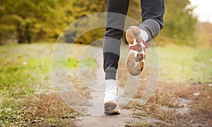 Running along a park path, healthcare and problem concept - close-up of an unhappy person suffering from pain in the leg or knee