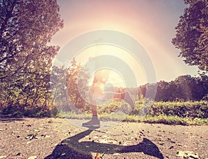 Man running on asphalt track. Athlete running fast in a park