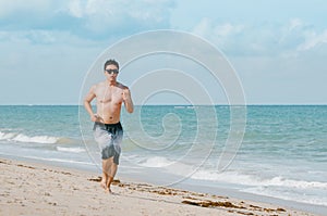 Man running on the beach photo