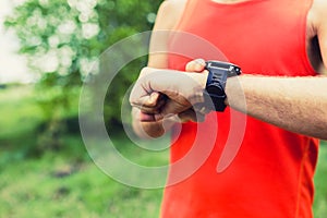 Man running and checking sport smart watch