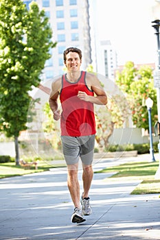 Man running in city park