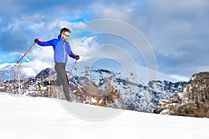 A man running downhill with snowshoes