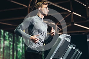 Man running in a gym on a treadmill