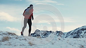 Man running at the mountain with snow