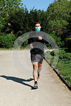 Man running in park with a face mask