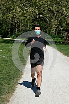 Man running in park with a face mask