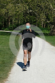 Man running in park with a face mask